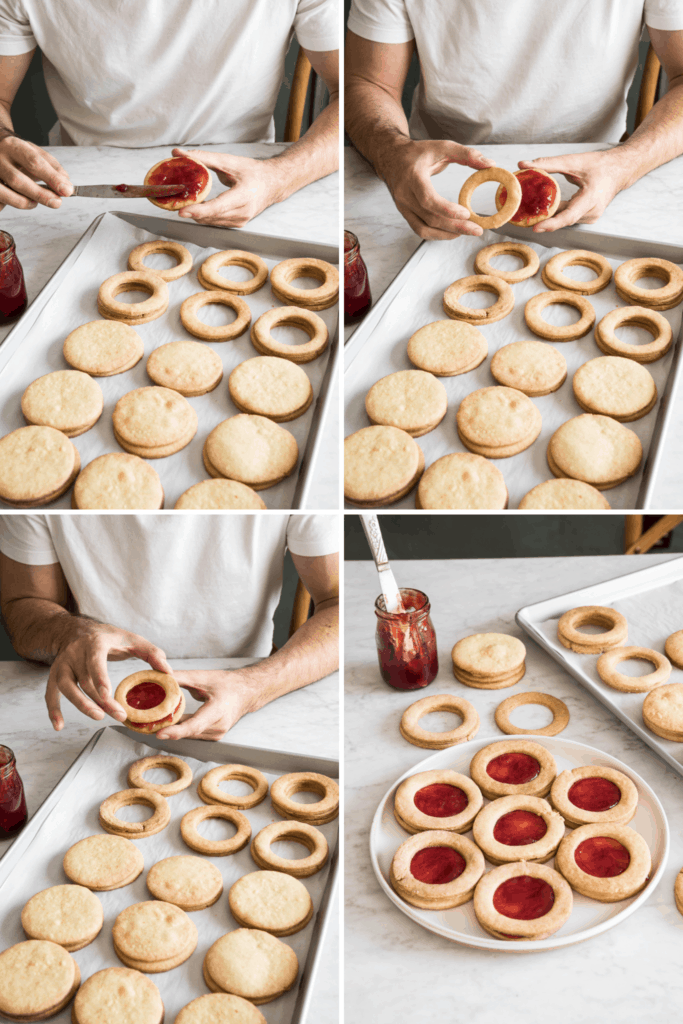 spreading raspberry jam on linzer cookies