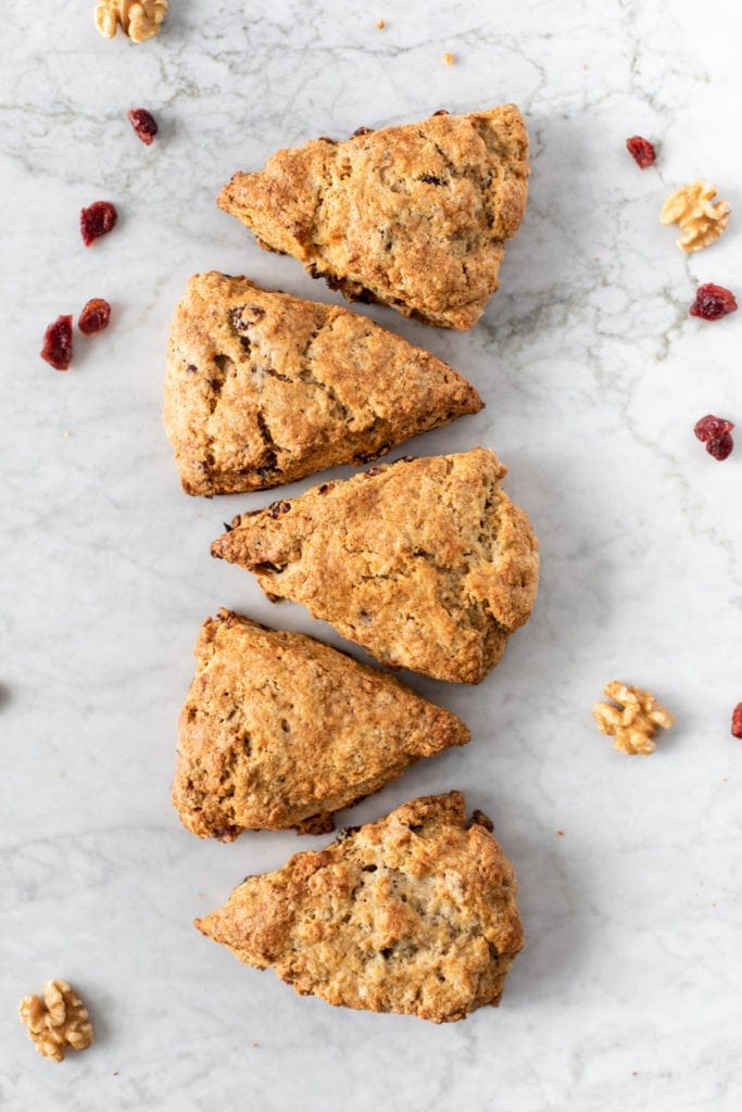 five cranberry walnut scones on a marble surface