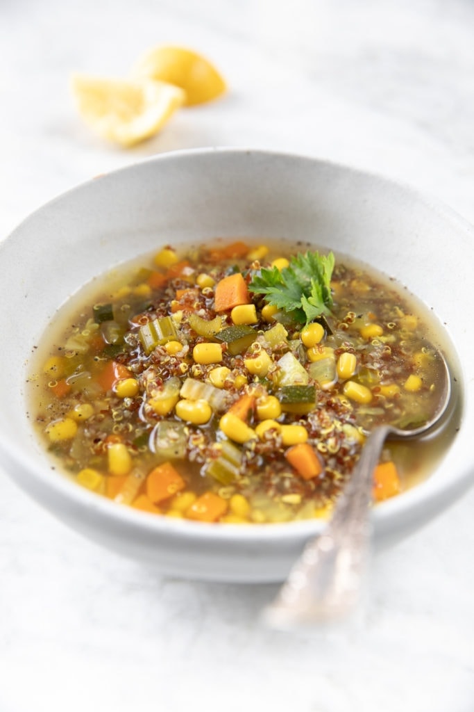 Here's a soup that will only take you minute to make! This quick and easy quinoa recipe is deliciously mixed with corn, carrots, and zucchini, and packed full of flavor. Perfect for weeknight dinners! #dinnerrecipe #soup #quinoarecipe