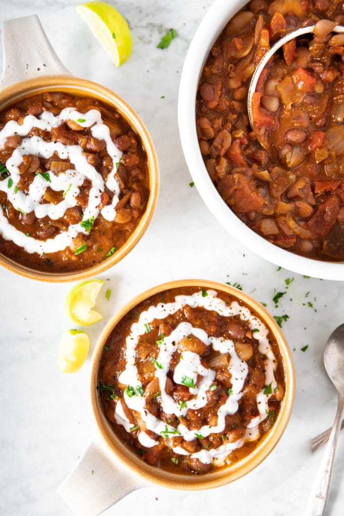 two bowls and a pot of vegan heirloom-bean chili