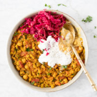 Plate of harira, a North African stew made with chickpeas, lentils, rice and vegetables. Served with sauerkraut and yogurt, from verygoodcook.com