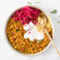 Plate of harira, a North African stew made with chickpeas, lentils, rice and vegetables. Served with sauerkraut and yogurt, from verygoodcook.com
