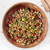 Wooden bowl with Easy Chickpea Salad With Tomatoes and Cucumbers