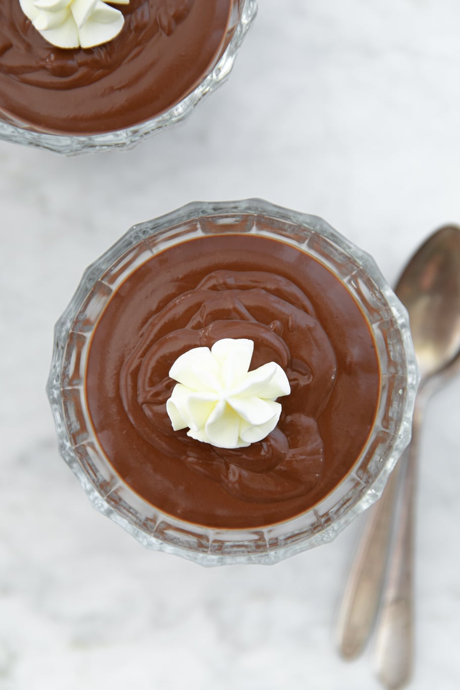 Glass bowls with double-chocolate pudding (budino) and whipped cream on top